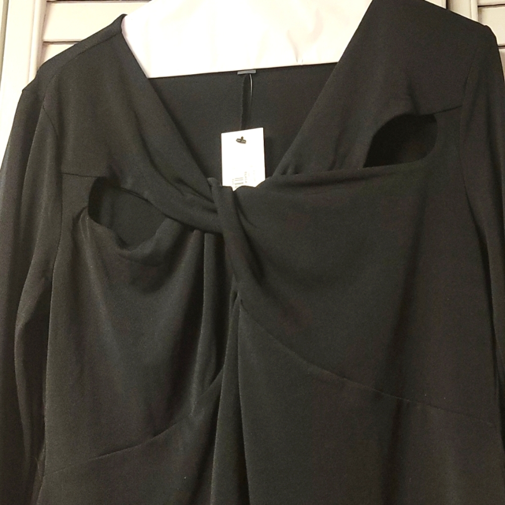 Ladies black long sleeve top. Features two peep cut outs across each shoulder.